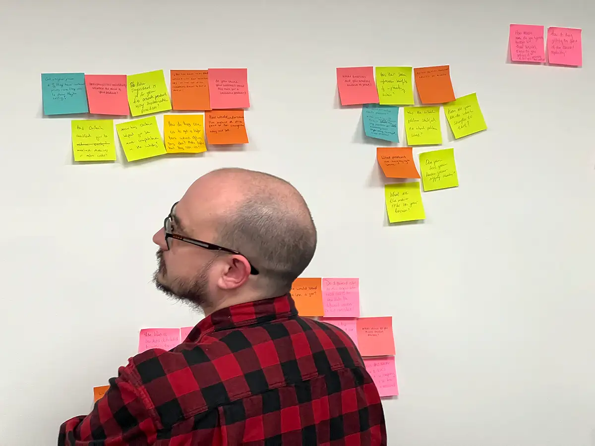 An Oritain teammate contributes to an assumption mapping workshop—helping establish a shared baseline and shape the research plan.